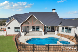 Exterior elevation of a custom home home with a pool and covered patio