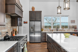 a custom home kitchen with stainless steel appliances and wood floors